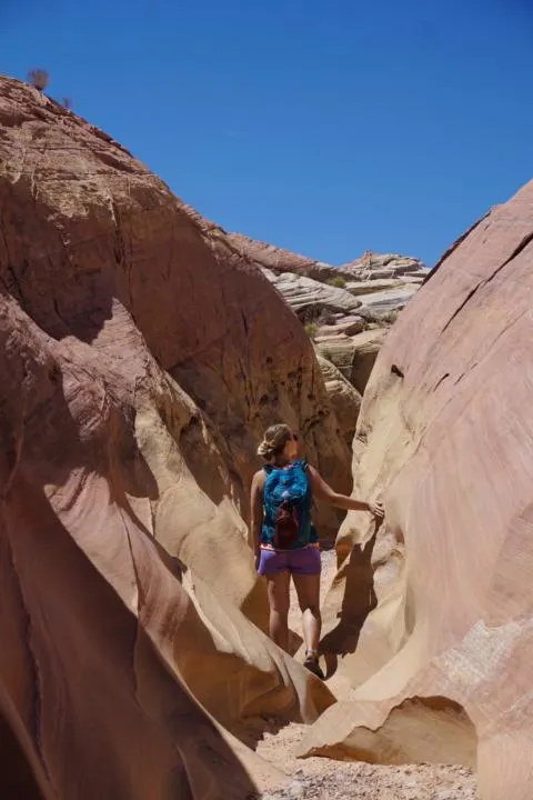 Emily walking through the pastel colors of Pink Canyon.