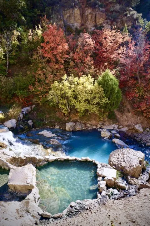 Fifth Water Hot Springs during fall with beautiful tree colors with the aqua blue hot springs which is one of the best hikes in utah
