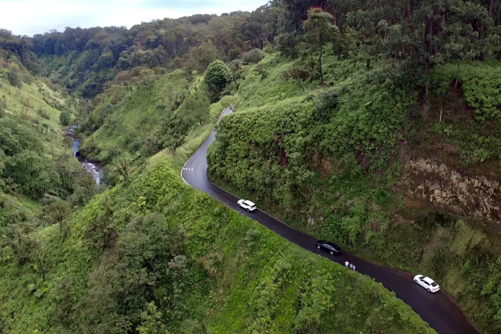 Arial drone photo of several cars driving the Road to Hana.