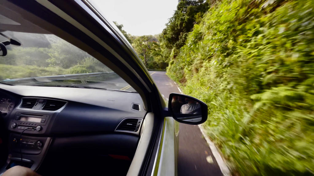 Driving the Road to Hana in a rental car.