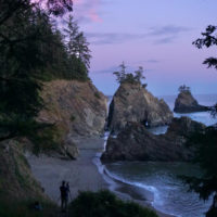 A photographer sets up to capture sunset photos at Secret Beach on Oregon's Southern Coast.