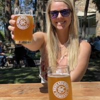 Em holding a beer at Bend Brewing Company is one of the stops on our self-guided brewery tour in bend
