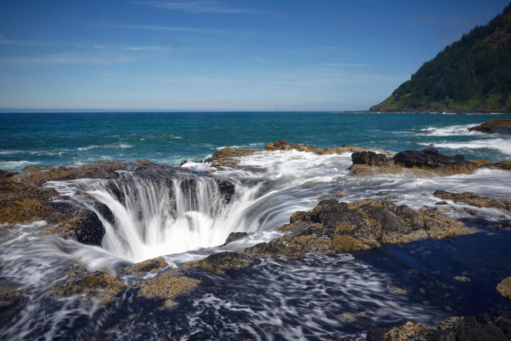 A long exposure photo of Thor's well which is one of the top things to do in Yachats, Oregon