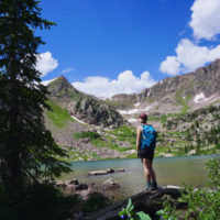 Emily standing at the edge of Gore Lake, one of the best hikes in Vail.