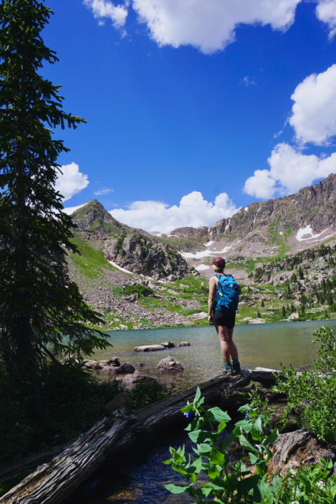Emily standing at the edge of Gore Lake, one of the best hikes in Vail.