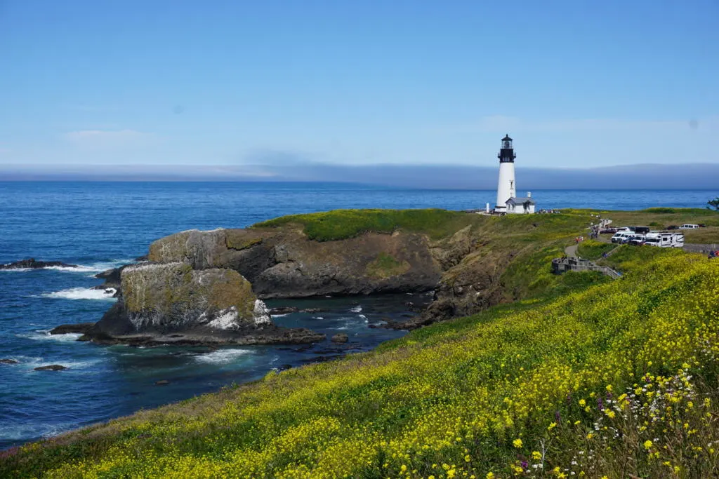 A view from afar of the Yaquina Head Lighthouse which is one of the tops things to do in Newport, OR