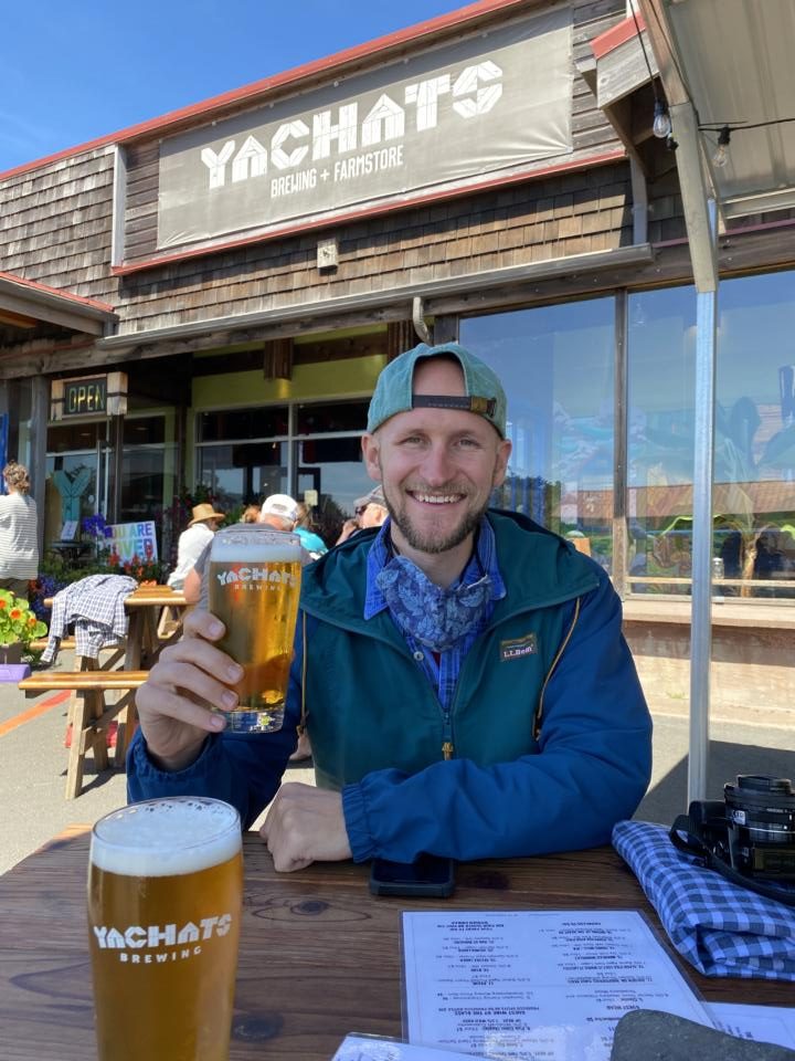 Jake holding up a beer at Yachats Brewery & Farmhouse Is one of the top things to do in Yachats, Oregon
