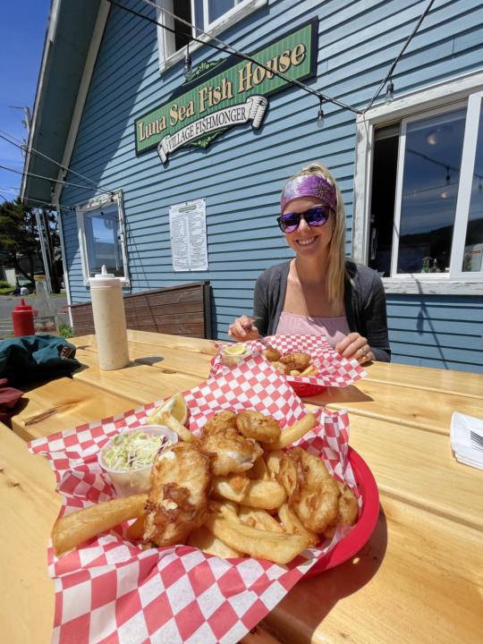 Emily eating a fish & chips at Luna Sea Fish House which is a must do on the list of top things to do in Yachats, Oregon