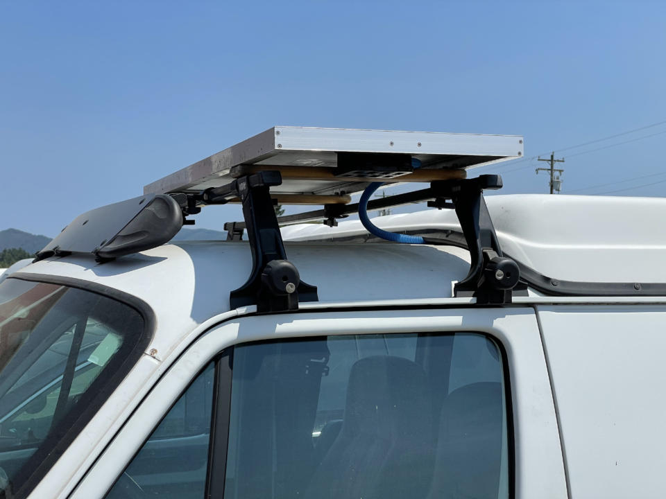 Thule gutter mounted roof rack for mounting on fiberglass hightop van.