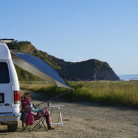 MoonShade Legs Up On Side Of Van showing one of the best awnings for camper vans