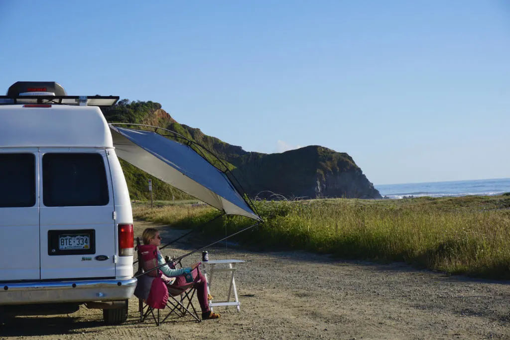 MoonShade Legs Up On Side Of Van showing one of the best awnings for camper vans