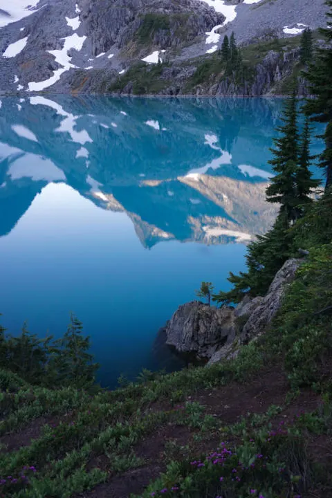 the reflection of Jade Lake on the stunning aqua blue water