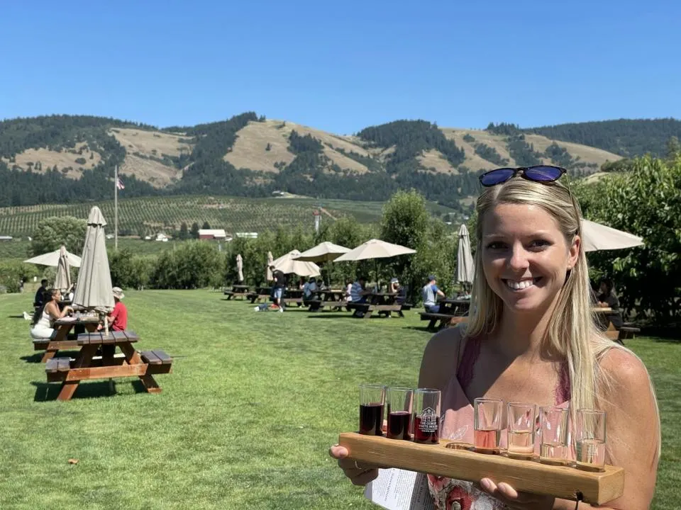 Emily with The Gorge White House Wine Flight which is a fun activity on the day trip from Portland to Mt. Hood