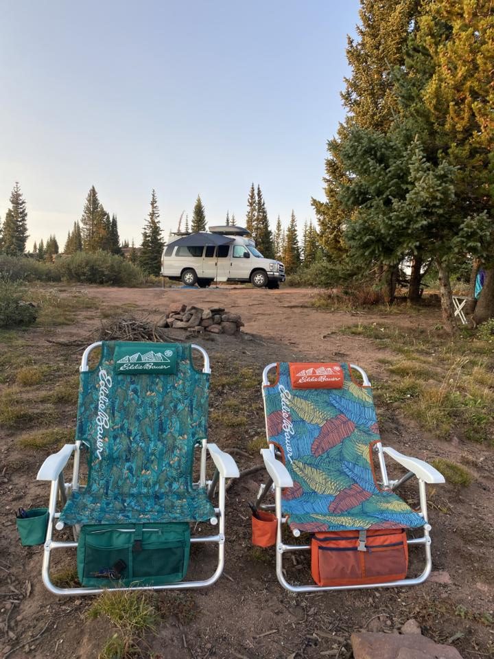 a picture with a van, hammock, awning, camp chairs, etc which are all great camper van accessories