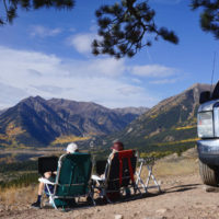 Jake and Emily sitting in their Eddie Bauer Beach Chairs at Twin Lakes, CO which is one of the best free campsites in the western U.S.