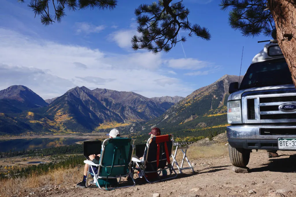 Jake and Emily sitting in their Eddie Bauer Beach Chairs at Twin Lakes, CO which is one of the best free campsites in the western U.S.