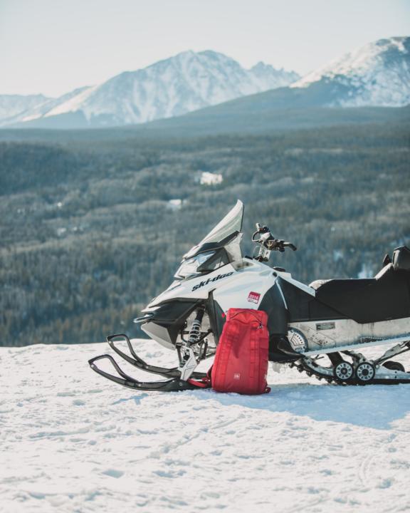 a snowmobile with snowy mountains in the distance