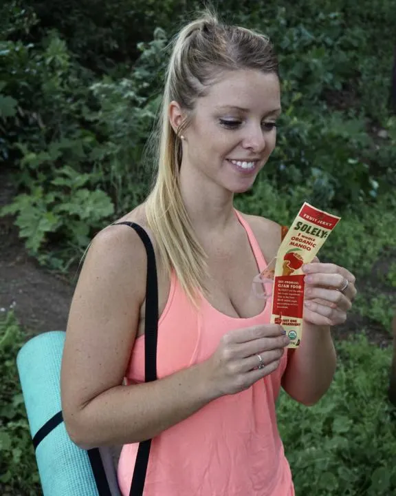 Emily eating a soley fruit jerky which is one of the best hiking snacks to fuel your next adventure