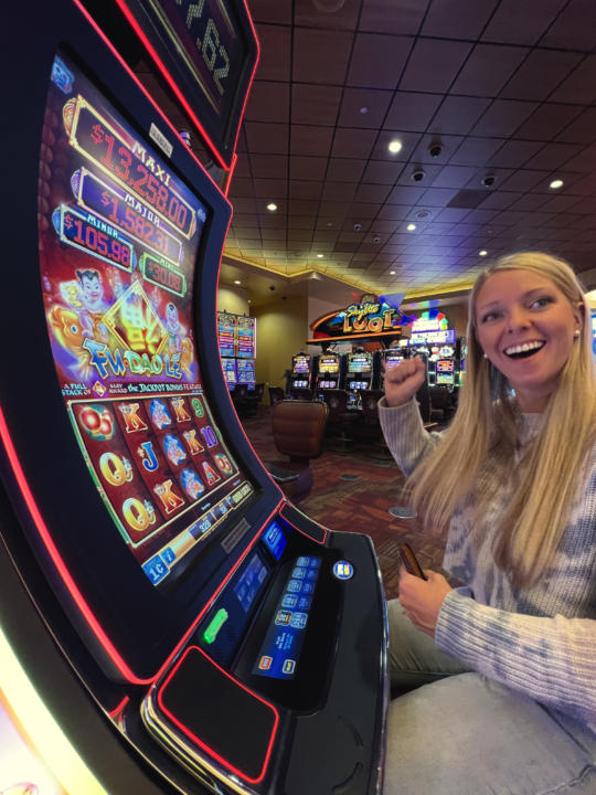 Emily getting psyched at the slot machines.