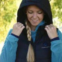 Emily using the Venustas Heated Vest w/ detachable hood out on a hike