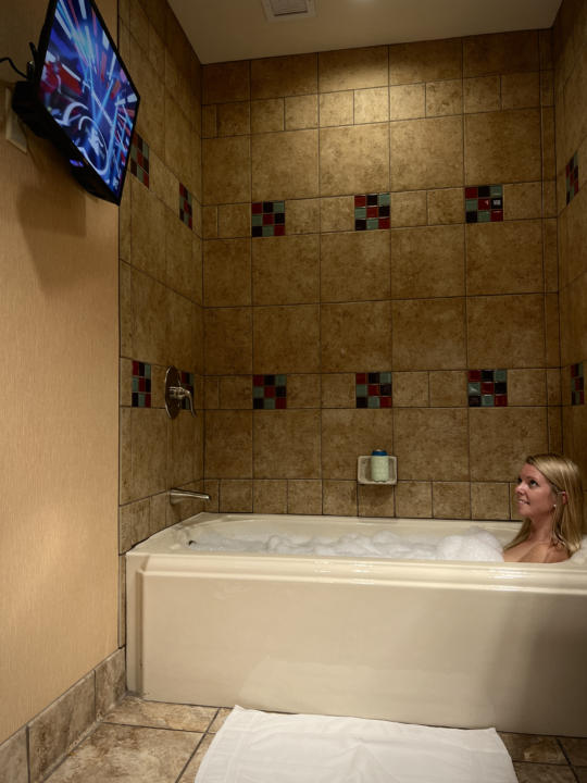 Emily enjoying a bubble bath while watching some tv.