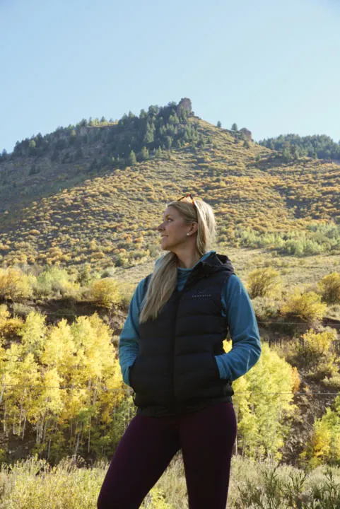 Emily using the Venustas Heated Vest w/ detachable hood out on a hike in Colorado