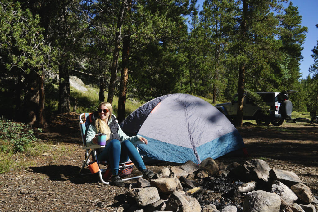 Emily using the Venustas Heated Vest on a camping trip in Colorado