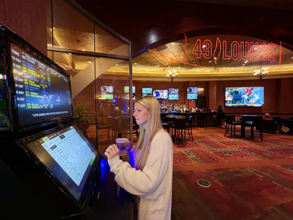 Emily placing a bet on her beloved Green Bay Packers.