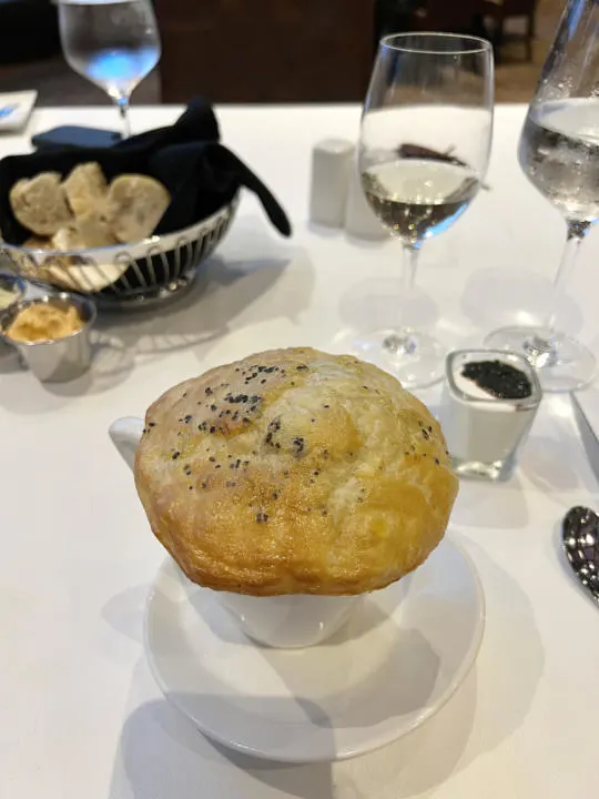 The lobster bisque appetizer with pastry cover and side of caviar and creme fraiche.