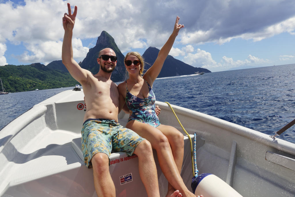 The Two Roaming Souls posing in front of the Pitons on a private boat charter in St. Lucia.