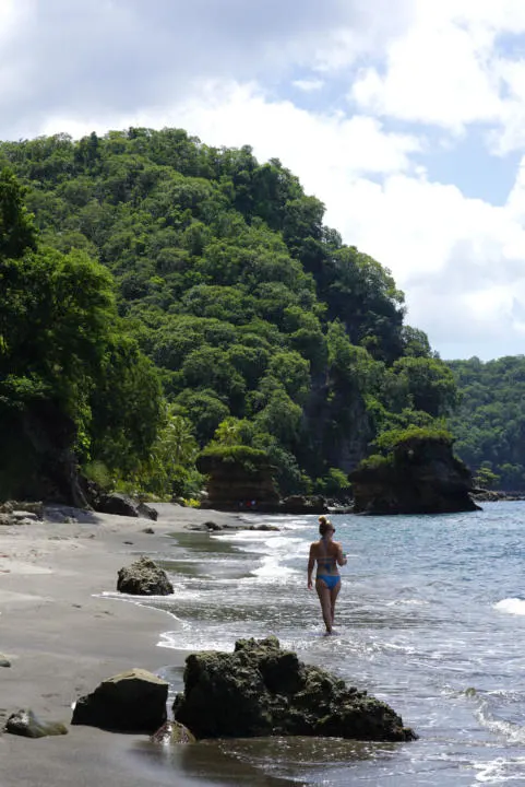 Emily walking the far north part of Anse Mamin Beach in St. Lucia.