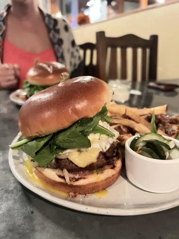 juicy burger with arugula and melted cheese at Street Burger, one of the best places to eat in Kauai