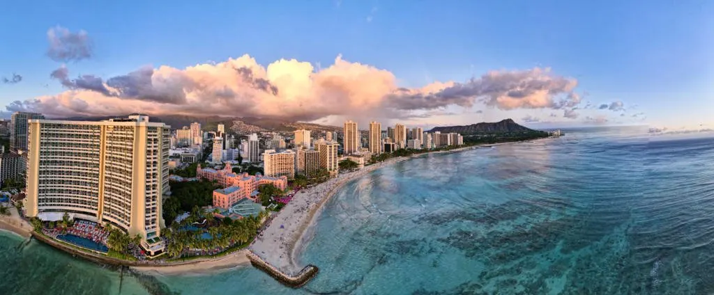 Waikiki Beach is lines with hotels and resorts.