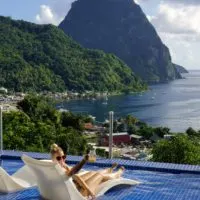 Emily cheersing her cocktail from the pool at Green Fig Resort, one of the best resorts in St. Lucia that offers epic views of Petit Piton