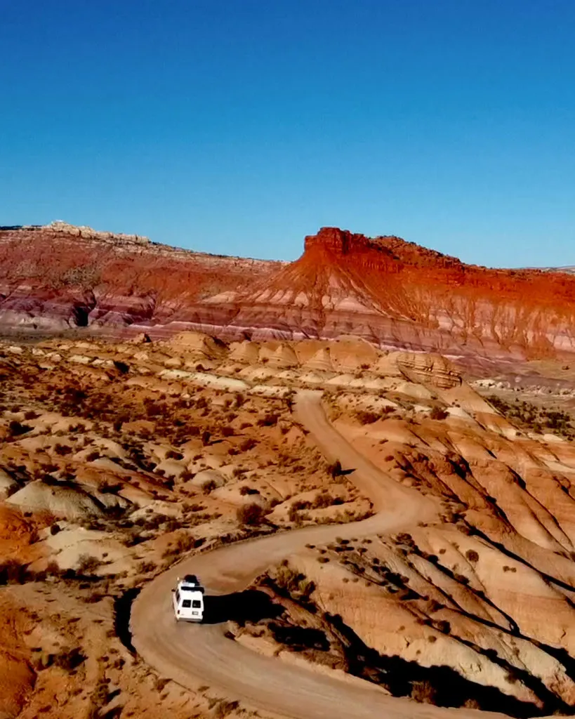 a van driving the scenic road along the Paria Rainbow Mountains