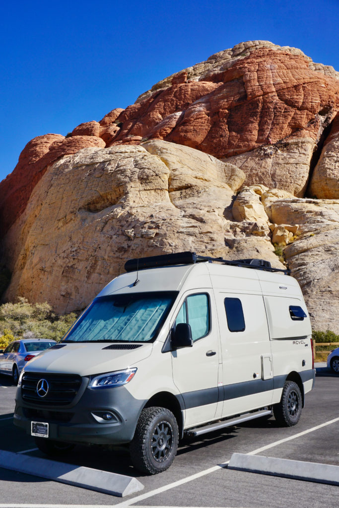 Mercedes Sprinter Campervan against sandstone background.