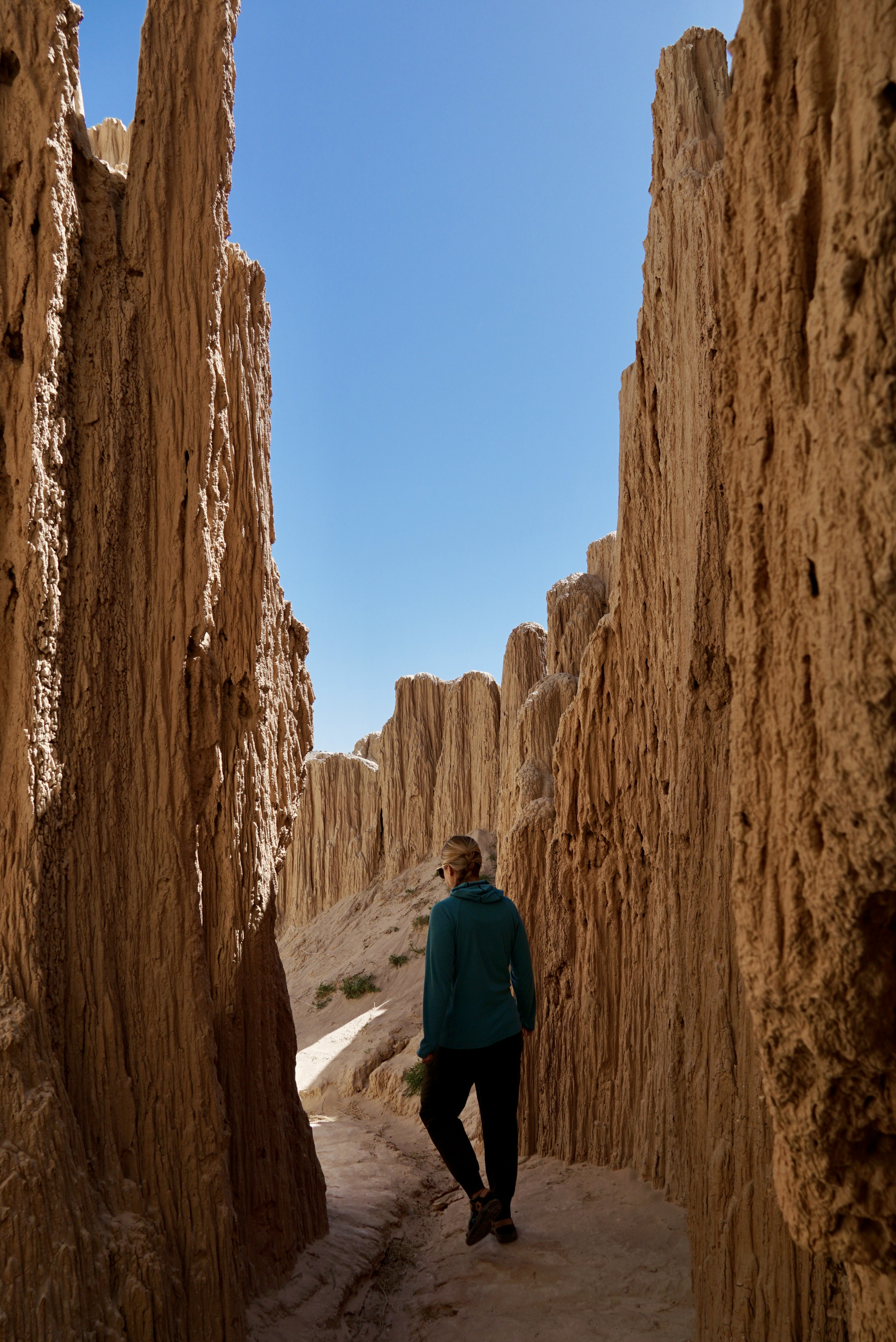 a girl walking through the Slot Canyons at Cathdral Gorge State Park