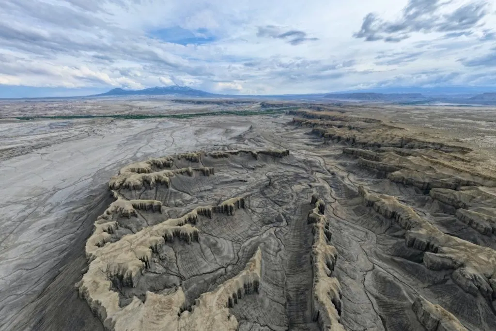 Time lapse tracking shot of Long Dong Silver spire rock over mud