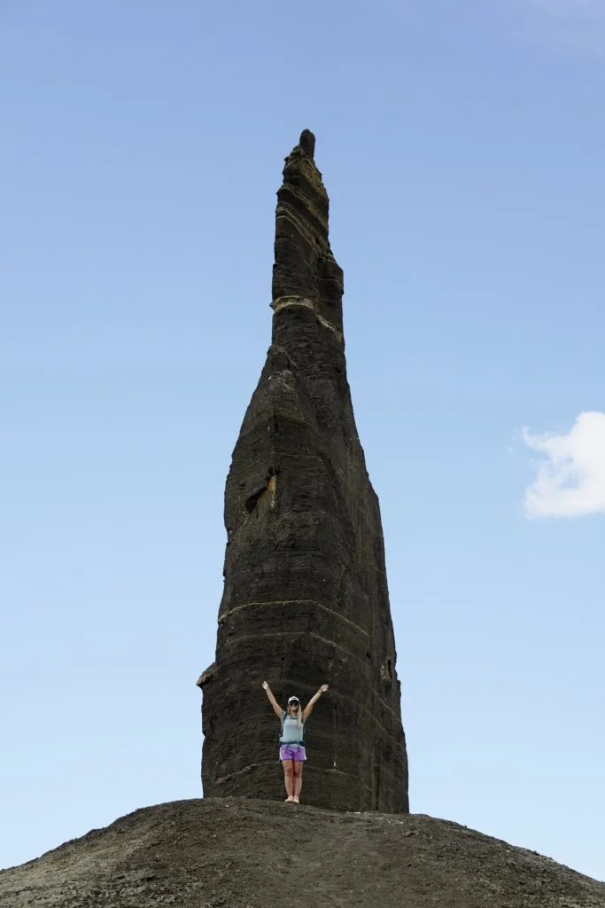 Time lapse tracking shot of Long Dong Silver spire rock over mud