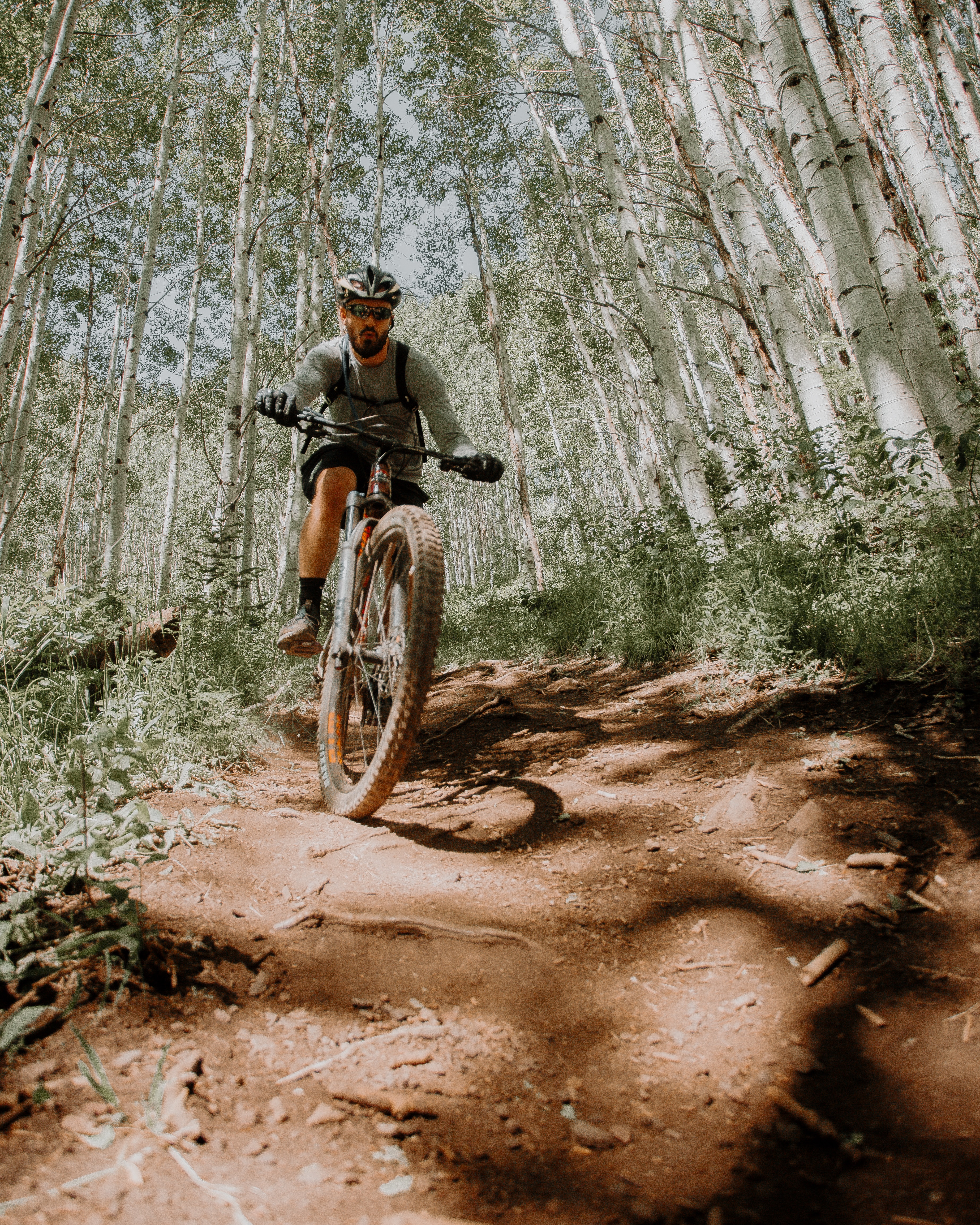 a guy mountain biking through aspen trees with is one of the best things to do in Buena Vista CO