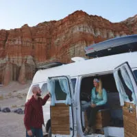 The Two Roaming Souls with their Ford E-350 campervan, one of the best vans to live in.
