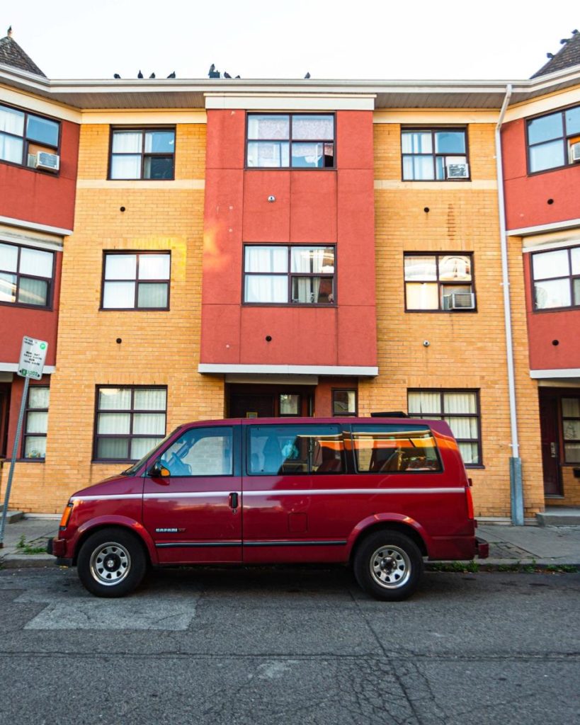 A maroon GMC Safari: one of the best vans to live in.