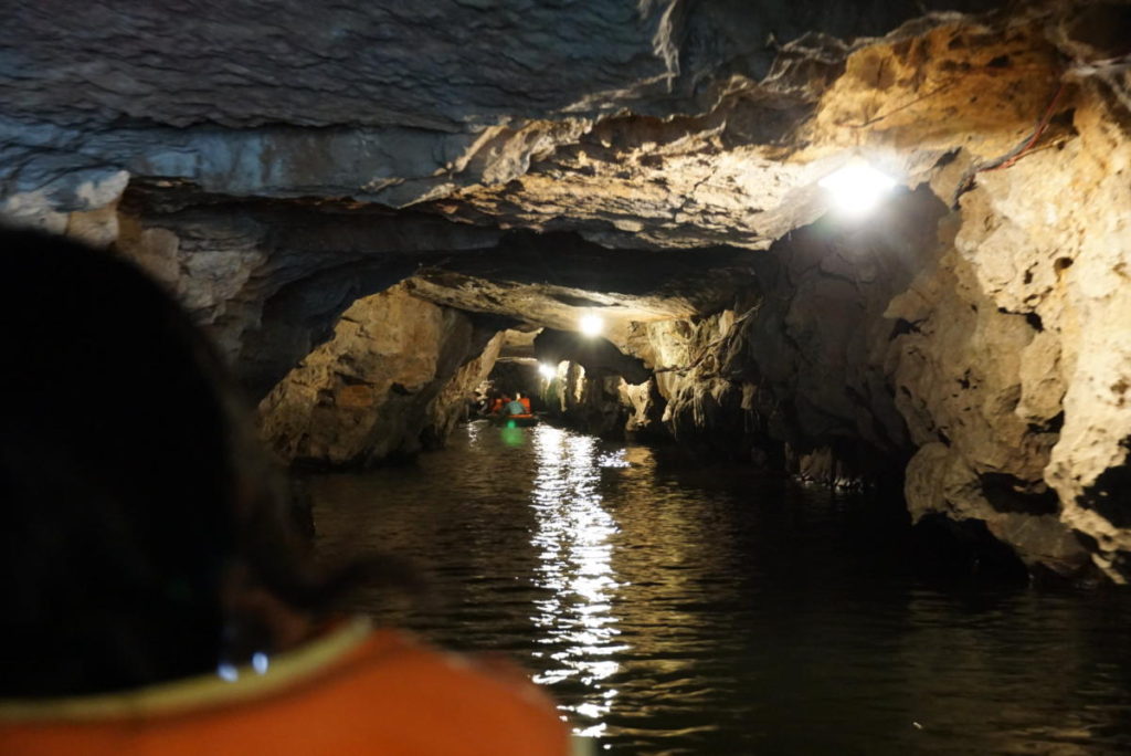 Going through a cave on the Trang An Boat Tour