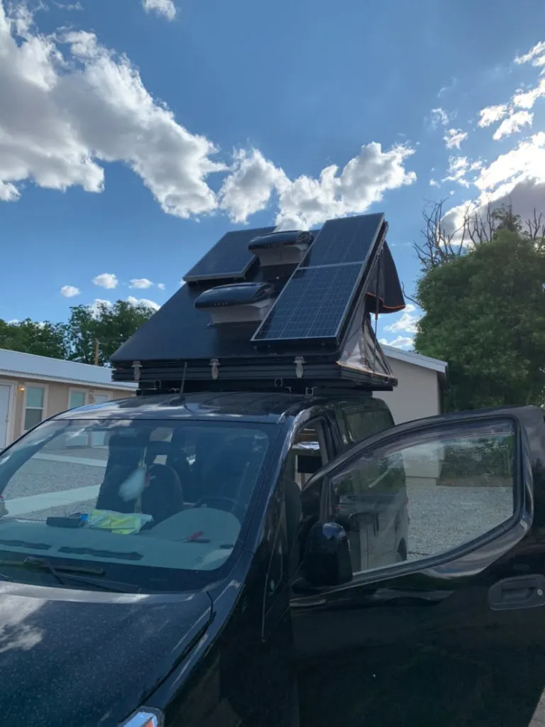 Custom Roofnest pop top campervan with tons of solar panels.