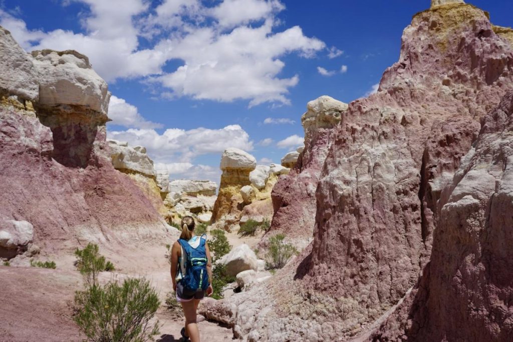 Emily hiking through the colorful sandstone-capped spires in the Paint Mines.