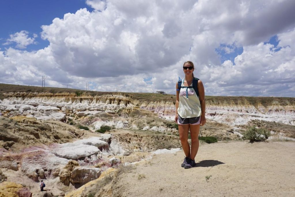 Emily standing on the rim of the Paint Mines amphitheater.
