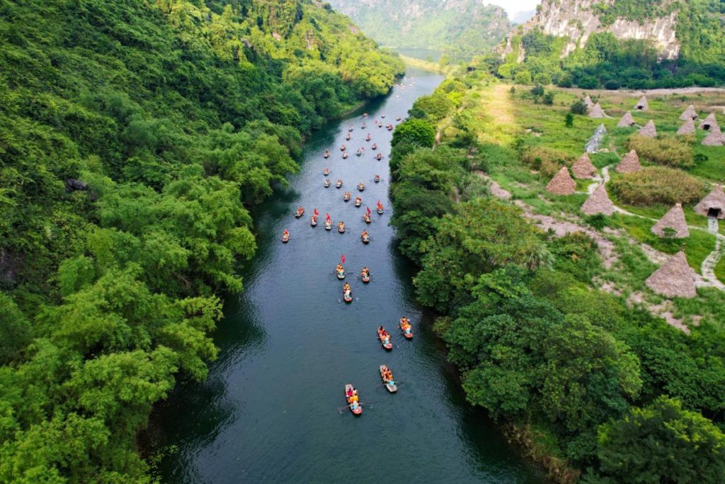 Aerial view of row boats coming down the Trang An with the Kong Skull Island Movie Set