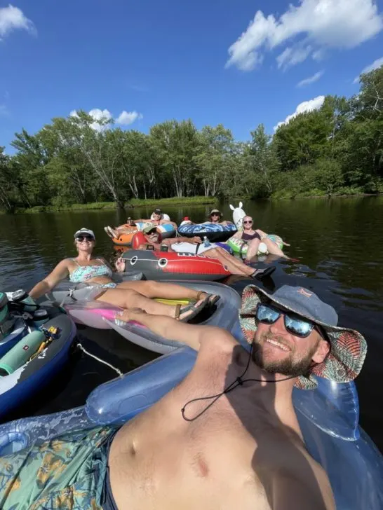 Group of 6 people on inflatable tubes, floating The Wisconsin River near Minocqua, WI