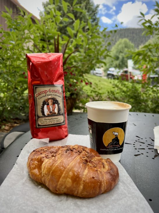 Camp 4 Coffee Bag of grounds with a pastry and latte in downtown Crested Butte, CO