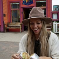 Emily opening a massive burrito from Teocali Tamale Burrito in Crested Butte, CO
